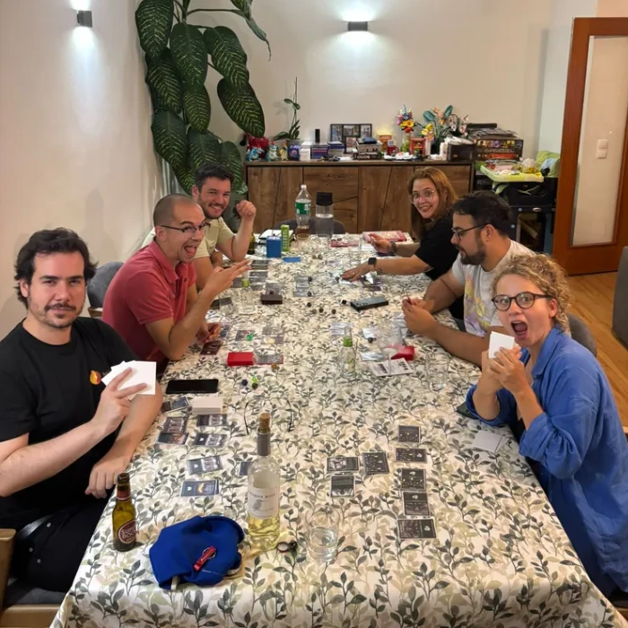 Six people gathered around a table during a Kravestorm playtest session in Portugal